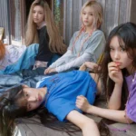 NewJeans' "Supernatural" MV teaser has garnered mixed reactions, with praise for its retro style and sophisticated sound countered by criticism of its New Jack Swing genre and association with producer Min Heejin.