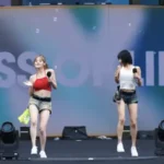 KISS OF LIFE, a rising K-pop girl group, faced criticism for their simple white t-shirts and denim shorts at the recent WATERBOMB Festival. However, this choice was made in consideration of a shirt-removal performance element.