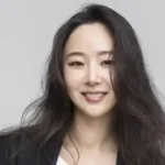 Min Heejin, CEO of ADOR, faces multiple lawsuits and a critical embezzlement accusation from HYBE, which could jeopardize her position and financial compensation.