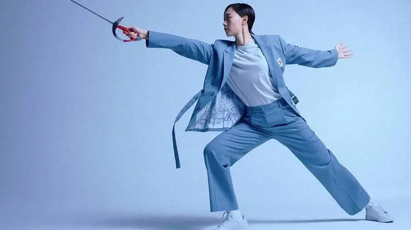 Musinsa Standard unveiled the Korean national team's uniforms for the Paris Olympics, fusing traditional Korean elements with modern style. The blue "belted suit setup" embodies youth and ambition, while the celadon porcelain pattern and "gakdae"-inspired belt add subtle hanbok touches.