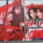 Photos of QWER members were defaced with red paint on a window of 3Y Corporation's office, drawing significant attention online. QWER's agency is investigating the red paint incident, while online communities speculate on the culprits, including possible anti-fan activity.